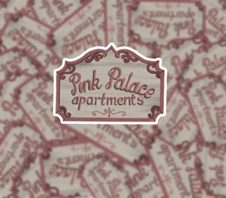 May include: A vintage-style sign with a pink and white color scheme. The sign reads "Pink Palace Apartments" in a decorative script font.