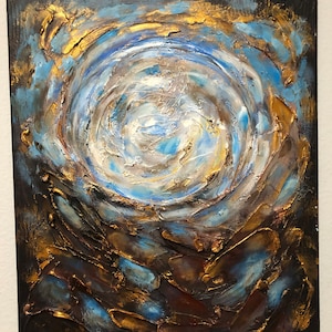 May include: Abstract painting with swirling blue, white, and gold paint on a black canvas. The paint is textured and raised, creating a three-dimensional effect.