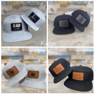 May include: Four different baseball caps with personalized leather patches. The patches feature the text "Dad Est 2022", "Arthur", "Rad Dad", "Legend Est 1995", and "Jenny Est 2021".