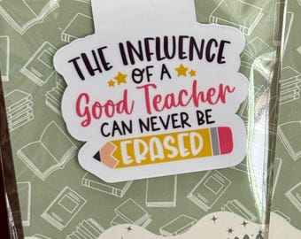 May include: A magnetic bookmark with the text "The Influence of a Good Teacher Can Never Be Erased." The bookmark has a white background with a colorful pencil design and stars. The background of the packaging is green with book illustrations.