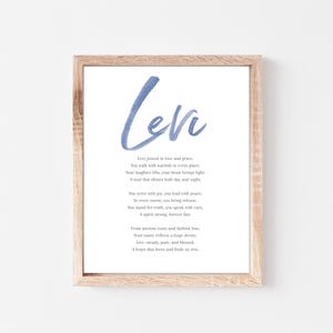 May include: A framed print with the name "Levi" in blue script at the top. Below, a poem about Levi is printed in a classic font. The frame is made of light-colored wood, and the background is white.