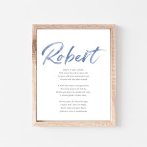 May include: A watercolor print with the name "Robert" in a blue script font. The print features a poem about the name Robert, describing it as bold, honorable, and true.