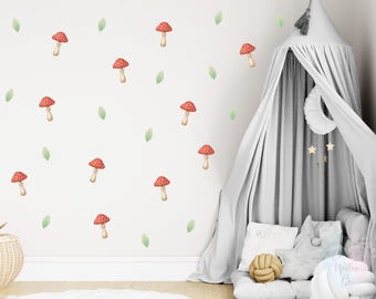 May include: A white wall decorated with red mushroom and green leaf decals. A gray canopy bed with pillows and a decorative knot pillow is in the corner. The room has a whimsical, nature-inspired theme.