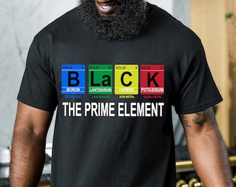 May include: Black t-shirt with a graphic of the word "BLACK" spelled out using the chemical element symbols for Boron, Lanthanum, Carbon, and Potassium. The text "THE PRIME ELEMENT" is printed below the graphic.
