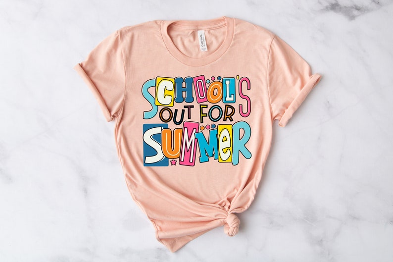 May include: A peach-colored t-shirt with the text "School's Out For Summer" in colorful, playful letters.