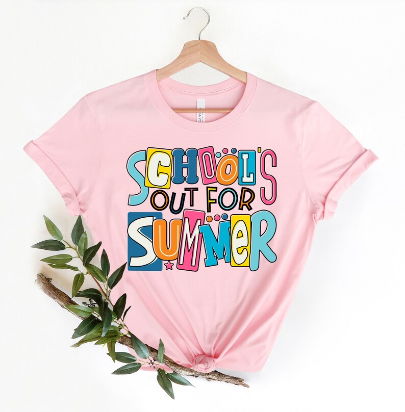 May include: Pink t-shirt with a colorful graphic that says "School's Out For Summer".