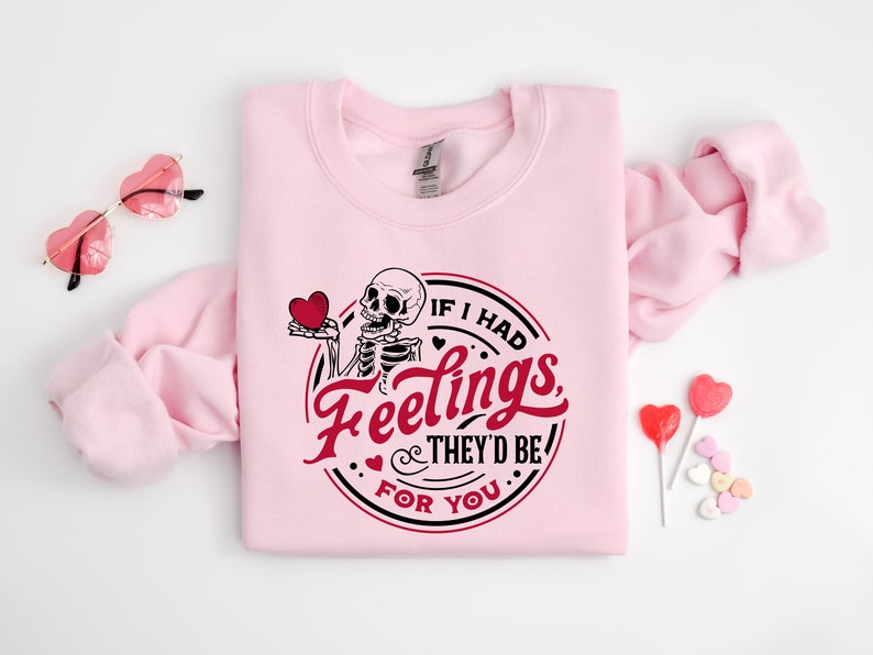 May include: Pink sweatshirt with a skeleton holding a heart and the text "If I had feelings, they'd be for you".