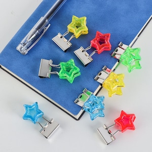 Star Shape Fashion Hollow Metal Binder 3/4 pulgadas Clips 16 Pcs / Set Notas fotográficas Carta Clips de papel Papelería Lindo aglutinante Clips Kawaii Fotos