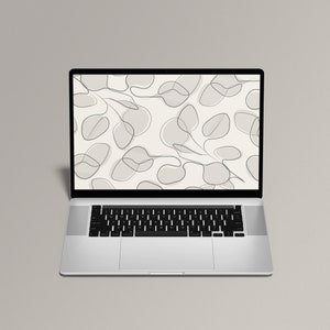 Puede incluir: Un ordenador portátil plateado con un teclado y un trackpad negros. La pantalla muestra un fondo blanco con un patrón de formas abstractas grises y líneas.