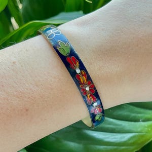 Vintage Enameled Cloisonné Bangle Bracelet Featuring Gold Tone Metal Base with Dark Blue Background and Red Orange Flowers