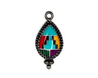 May include: A teardrop-shaped pendant with a silver-tone metal frame and bail. The pendant features a mosaic design with turquoise, red, yellow, black, green, and purple stones. The frame has a twisted rope design and three small silver-tone beads at the bottom.