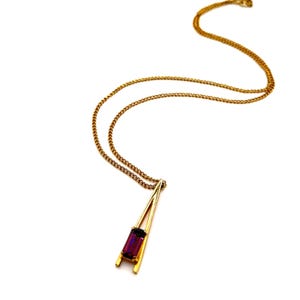 Vintage AVON Plaza IV Pendant Gold Tone Triangular Pendant with Purple Emerald Cut Rhinestone