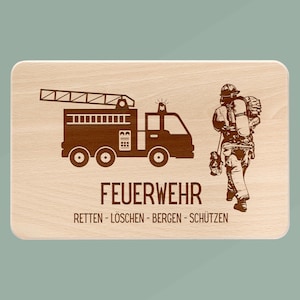 May include: A wooden sign with a brown illustration of a fire engine and a firefighter. The sign reads "FEUERWEHR RETTEN - LÖSCHEN - BERGEN - SCHÜTZEN".