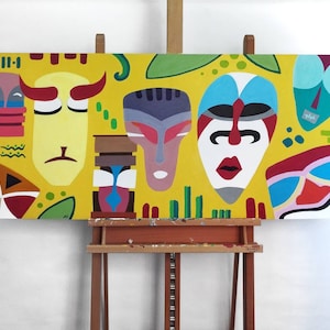 May include: Abstract painting on canvas featuring stylized mask designs in shades of yellow, red, blue, and white. The artwork includes geometric shapes and organic forms, creating a vibrant and colorful composition. The painting is displayed on an easel.