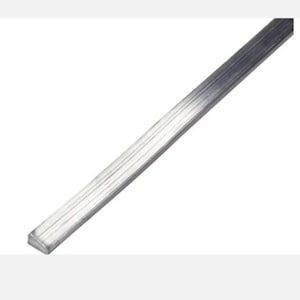May include: A close-up of a silver metal bar with a rectangular shape and a series of parallel grooves running along its length. The bar is angled diagonally across the frame against a white background.
