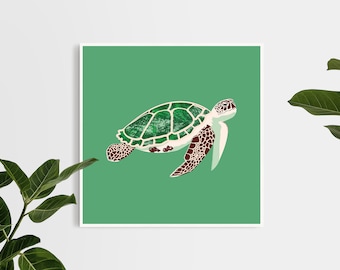 May include: A square art print featuring a sea turtle illustration. The turtle has a green and white shell, brown and white flippers, and a white head. The background is a solid green color. The print is displayed on a white wall with green plants.