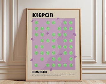May include: A framed wall art print featuring the text KLEPON and INDONESIA in black, bold font. The center displays a grid of small, textured green circles on a light purple background, accented by scattered purple leaf shapes on a beige field.