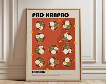 May include: A framed wall art print titled PAD KRAPAO THAILAND featuring a grid of eleven circular illustrations of Thai stir-fry dishes with rice and fried eggs on a terracotta background, accented by small yellow leaf shapes on a cream border.