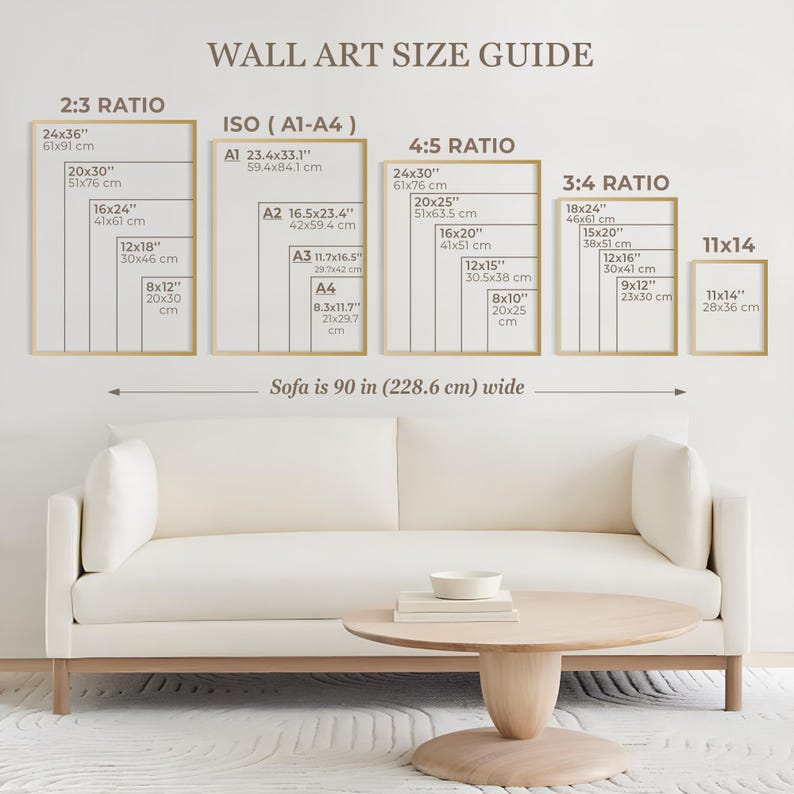 May include: A wall art size guide chart displaying various frame dimensions in inches and centimeters, categorized by ratios including 2:3, ISO A1-A4, 4:5, 3:4, and 11x14. The chart is positioned above a cream-colored sofa that is 90 inches wide.