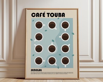 May include: A framed poster titled CAFÉ TOUBA SENEGAL featuring a grid of eleven white coffee cups filled with dark brown liquid on a light blue background. Small green leaves are scattered around the cups. The text at the bottom describes the coffee.