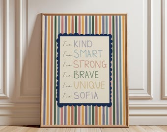 May include: A framed vertical wall art print featuring a background of multicolored vertical stripes in shades of blue, yellow, green, and pink. A central cream-colored rectangle with a dark blue scalloped border displays the text I am KIND, I am SMART, I am STRONG, I am BRAVE, I am UNIQUE, and I am SOFIA.