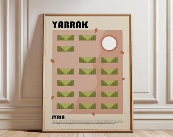 May include: A framed poster featuring the text YABRAK and SYRIA with a graphic illustration of green stuffed grape leaves arranged in rows on a light pink background, accented by small brown leaf shapes and a white circle.