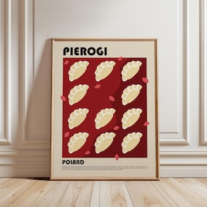 May include: A framed wall art print featuring the text PIEROGI and POLAND in black. The design displays a grid of twelve beige dumpling illustrations on a deep red background, accented by small scattered pink petals and descriptive text.