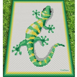 May include: A green and yellow crocheted gecko on a white background with a green and yellow border.