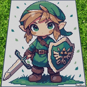 以下が含まれることがあります： ゼルダの伝説ビデオゲームシリーズのリンクのピクセルアートスタイルのクロシェパターン。リンクは緑のチュニックを着て、剣と盾を持っています。パターンは緑の葉のある白い背景にあります。