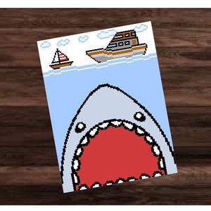 May include: A cartoon illustration of a large, open-mouthed shark with a red mouth and white teeth. A small sailboat and a larger boat are visible in the background, above the waterline.