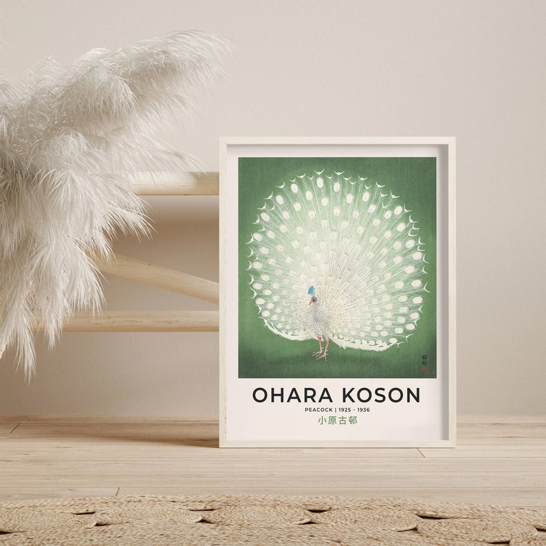 May include: A vintage poster featuring a white peacock with its tail feathers spread out in a fan shape. The peacock is on a green background. The poster is titled "Ohara Koson" and includes the text "Peacock | 1913 - 1936" and "小原古邨".