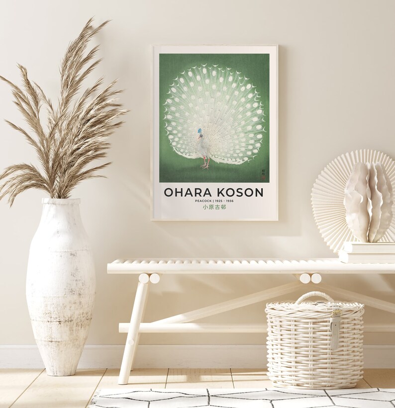 May include: A vintage poster featuring a white peacock with its tail feathers spread out. The poster has a green background and the artist's name, "Ohara Koson", is printed at the bottom. The text "Peacock 1923 - 1936" and "小原古邨" are also printed on the poster.