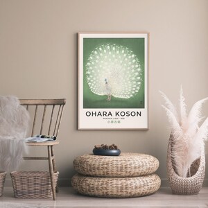 May include: A framed poster with a white peacock with its tail feathers spread out. The background is a green color. The poster has the text "OHARA KOSON" and "PEACOCK 1925 - 1956" and "小原古邨" in Japanese.