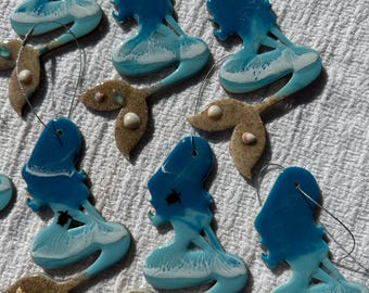 Mermaid Christmas ocean wave ornaments. Blue ocean coastal  Christmas ornaments with sand and shells. Mermaid silhouette