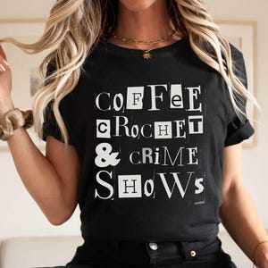 May include: Black t-shirt with white text that reads "COFFEE CROCHET & CRIME SHOWS".