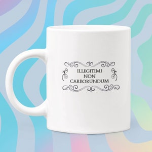 May include: White ceramic coffee mug with a black and white design that says "Illegitimi Non Carborundum".