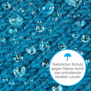 May include: Close-up of a blue fabric with water droplets on it. A white circle with a blue umbrella icon and text reads "Natural protection against moisture through the contained Wollfett Lanolin."