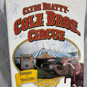 May include: Vintage Clyde Beatty-Cole Bros. Circus program and magazine. The cover features the circus name in red and yellow lettering, an illustration of the circus tent, an elephant, and signatures. The ticket booth is visible.