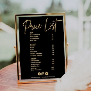 May include: A black framed price list with gold lettering for a hair salon. The list includes prices for haircuts, blowouts, braids, curls, straightening, Olaplex treatments, Brazilian blowouts, full highlights, partial highlights, all over color, root touch-ups, balayage, and color correction.