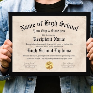 May include: A black framed diploma certificate with a gold seal. The text reads "Name of High School", "Your City & State here", "Recipient Name", "High School Diploma", "Awarded on this 15th Day of September in the year 2025", "School Principal", and "Assistant Principal".