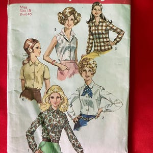 May include: Vintage Simplicity sewing pattern number 8399 for a women's blouse. The pattern includes five different styles of blouses, with long and short sleeves, and a variety of collars and necklines. The pattern is for a size 18, bust 40.
