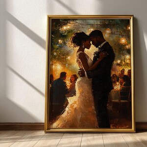 May include: A framed painting depicts a couple embracing at a wedding reception. The bride wears a white gown, and the groom is in a black suit. Soft lighting and blurred figures in the background create a romantic atmosphere. The frame is gold.