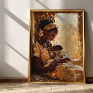 May include: A framed painting depicts a mother cradling a baby. The artwork features warm tones of gold, brown, and yellow. The mother wears a patterned dress and a head wrap. The baby is swaddled in a light-colored cloth. The frame is gold.