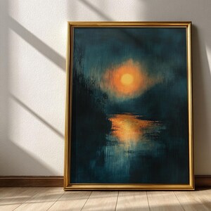 May include: Abstract landscape painting in a gold frame. The artwork depicts a vibrant orange sun reflecting on a body of water, set against a dark teal background. The painting is displayed on a wooden floor.