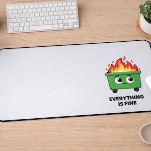 May include: White rectangular mousepad with a black border. The mousepad features a cartoon green dumpster on fire with the text "EVERYTHING IS FINE". A white mouse and a keyboard are also visible.