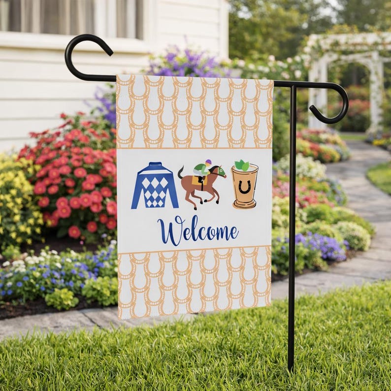 Puede incluir: Una bandera de jard&iacute;n decorativa con un patr&oacute;n de herraduras y gr&aacute;ficos tem&aacute;ticos de carreras. La bandera incluye los colores de un jockey, un caballo y un jinete, y un c&oacute;ctel. La palabra "Welcome" est&aacute; escrita en una fuente cursiva.