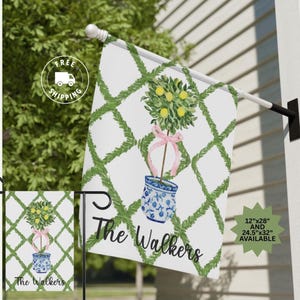 May include: A white garden flag with a green trellis pattern and a lemon tree in a blue and white planter. The text "The Walkers" is printed in black at the bottom of the flag. The flag is available in two sizes: 12" x 28" and 24.5" x 32".