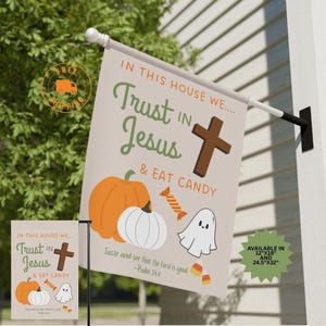 May include: A beige garden flag with the text "IN THIS HOUSE WE... Trust IN Jesus & EAT CANDY" and a cross, pumpkins, candy, and a ghost. The flag is available in 12"x18" and 24.5"x32" sizes.