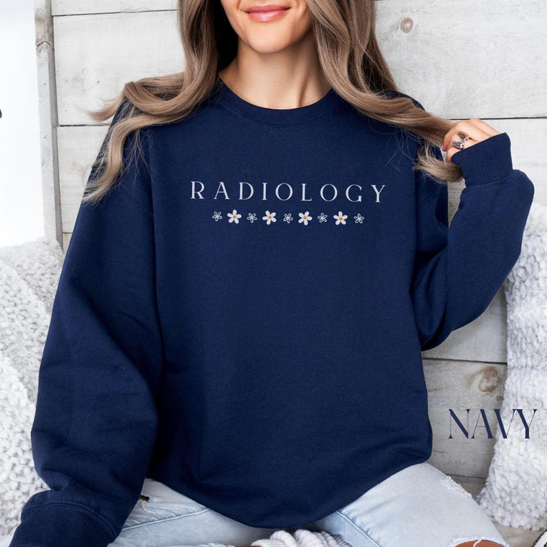 May include: Navy blue sweatshirt with the text "RADIOLOGY" and a row of small white flowers below the text.