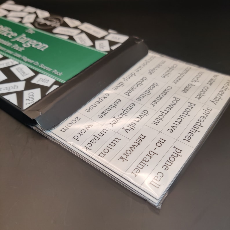 May include: A set of white cards with black text, featuring common office jargon terms. The cards are arranged in a stack, with the top card showing the text "phone call". The cards are labeled with terms like "spreadsheet", "water cooler", "touch base", "powerpoint", "network", "computer", "customer", "diversify", "union", "corporate", "deep dive", "expense", "manage", "dedicated", "estimate", "capable", "deadline", "employer", "unpack", "word", "zoom", "sale", "pin", "shred", "copy", and "graph".